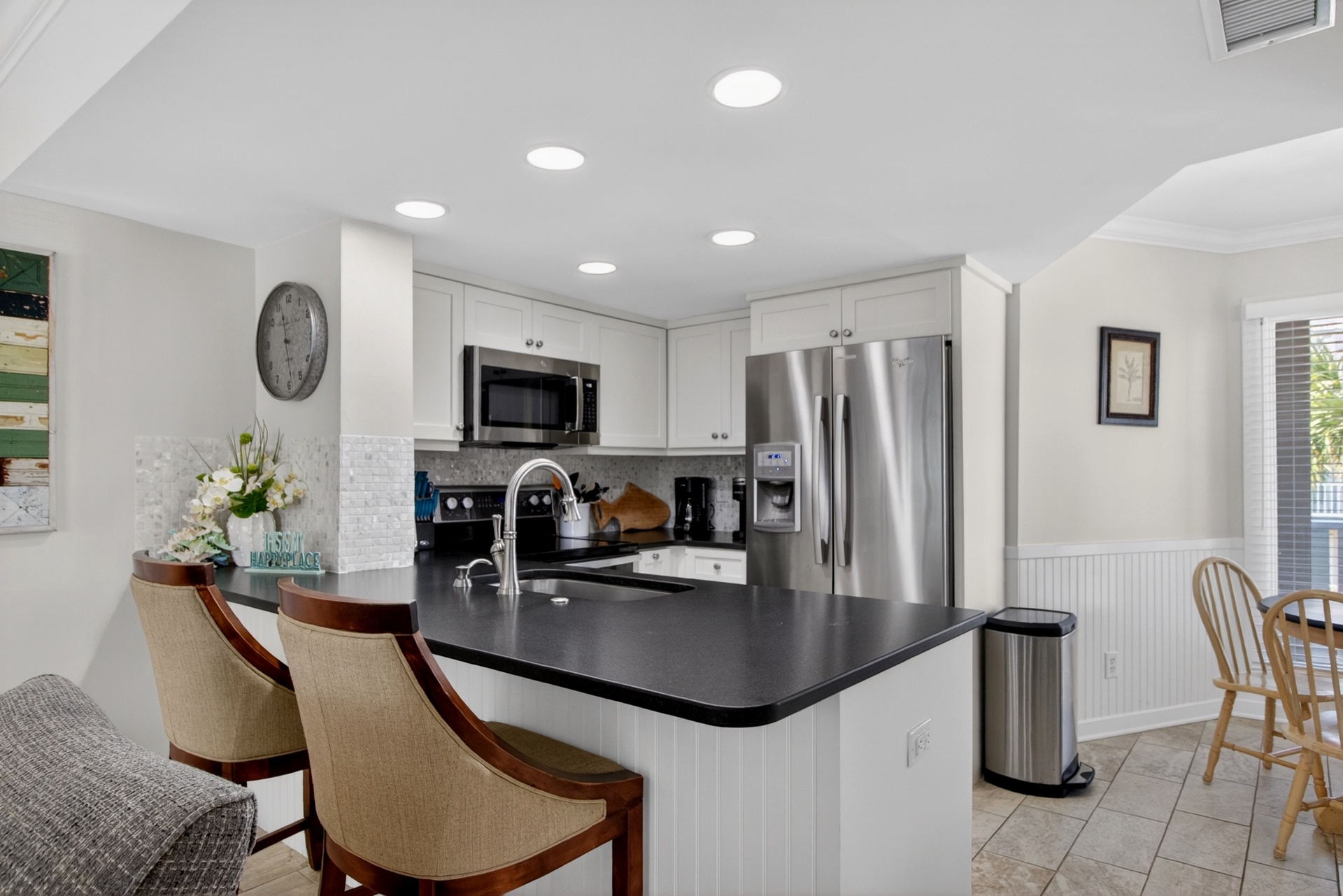 Step into your fully-equipped kitchen with sleek countertops, modern appliances, and a breakfast bar perfect for morning coffee or casual meals together.