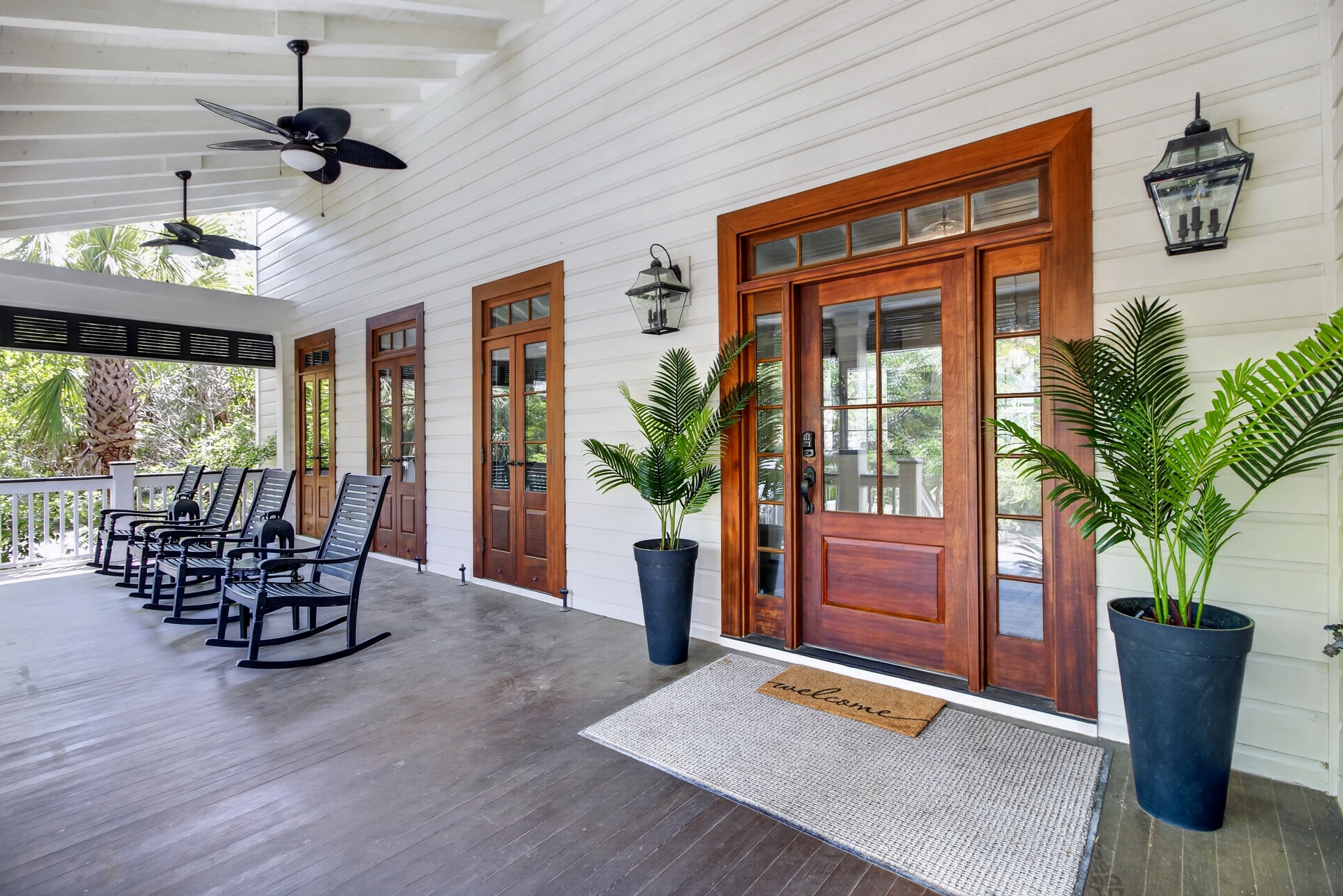 Step onto your welcoming covered porch where ceiling fans and rocking chairs create the perfect spot to unwind with tropical breezes.