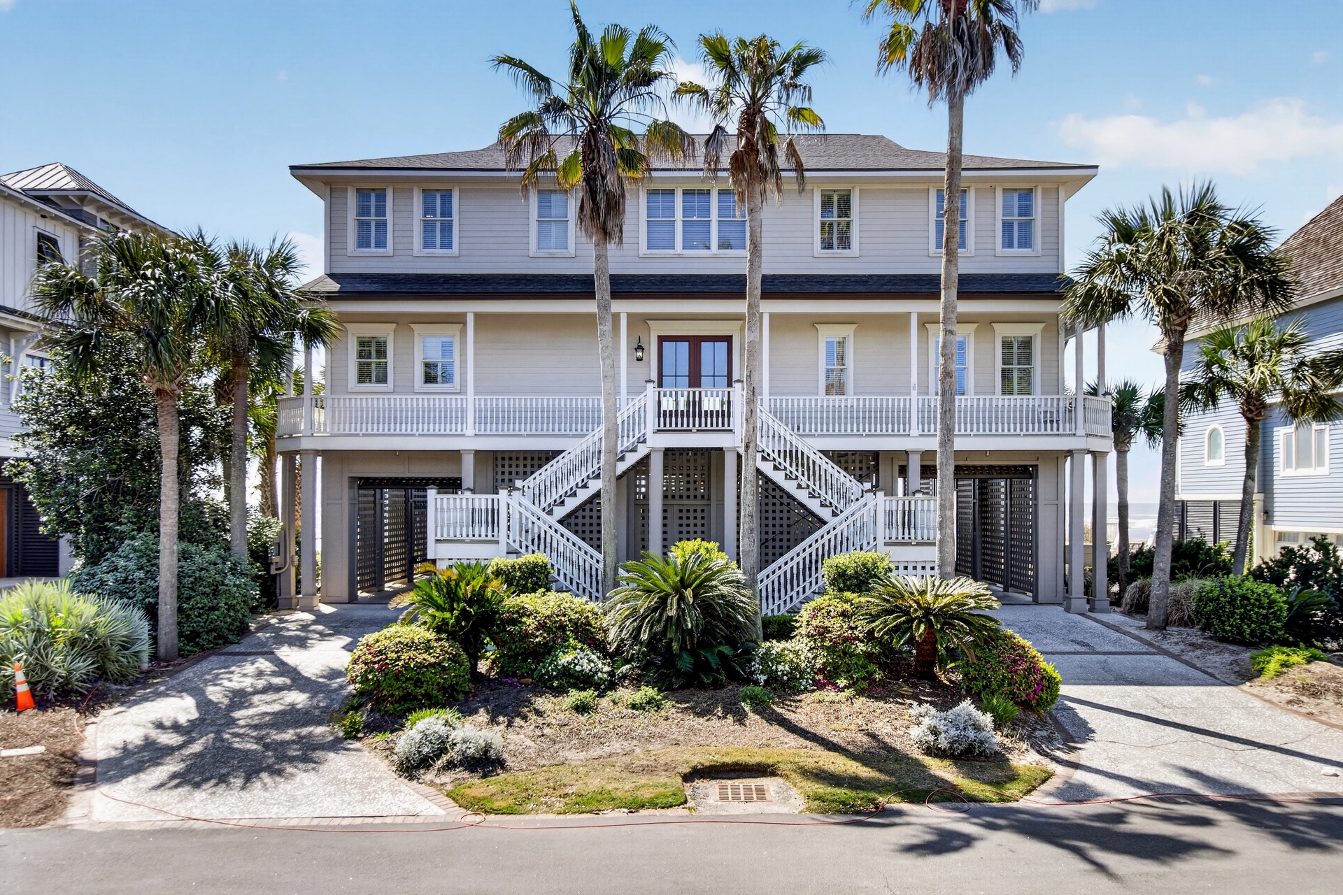 Elegant coastal property featuring tropical landscaping and elevated architecture in a charming residential setting.