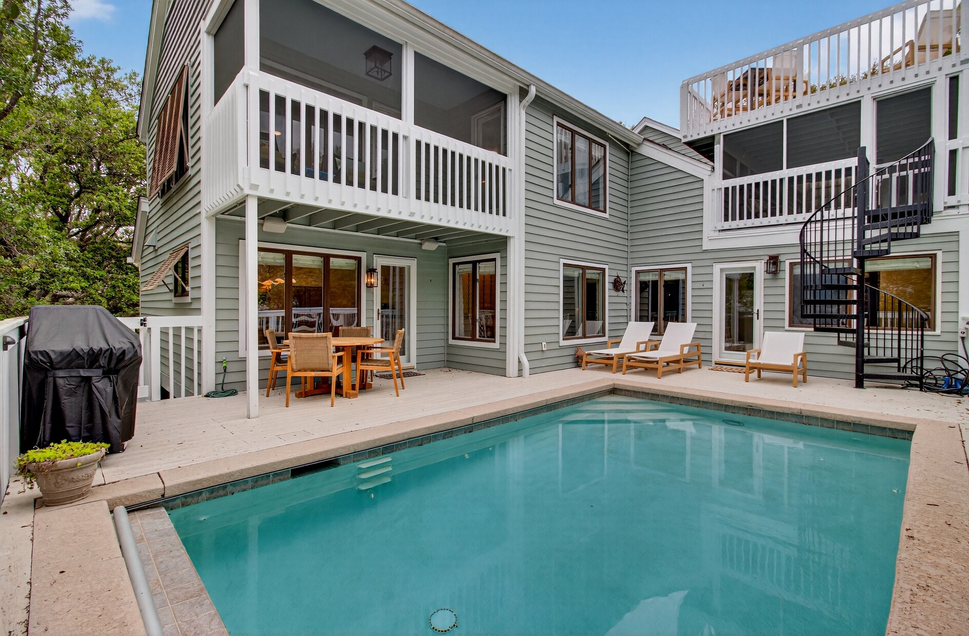 Your private pool awaits with teak loungers and outdoor dining for perfect poolside relaxation.