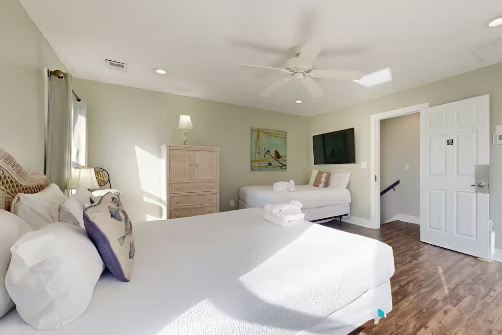 Drift into peaceful sleep in your bright, airy bedroom with crisp white linens and coastal charm.