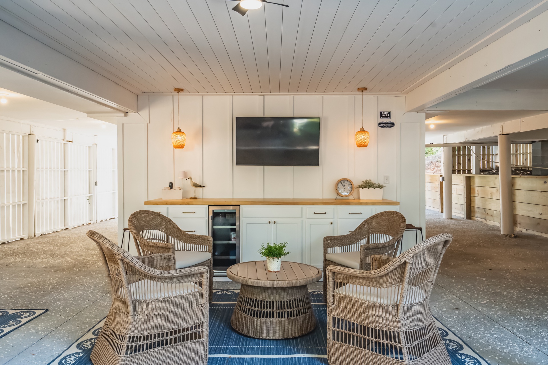 Gather in this charming communal space, where wicker chairs invite you to relax with friends and the warm wood accents create a welcoming atmosphere perfect for unwinding together.