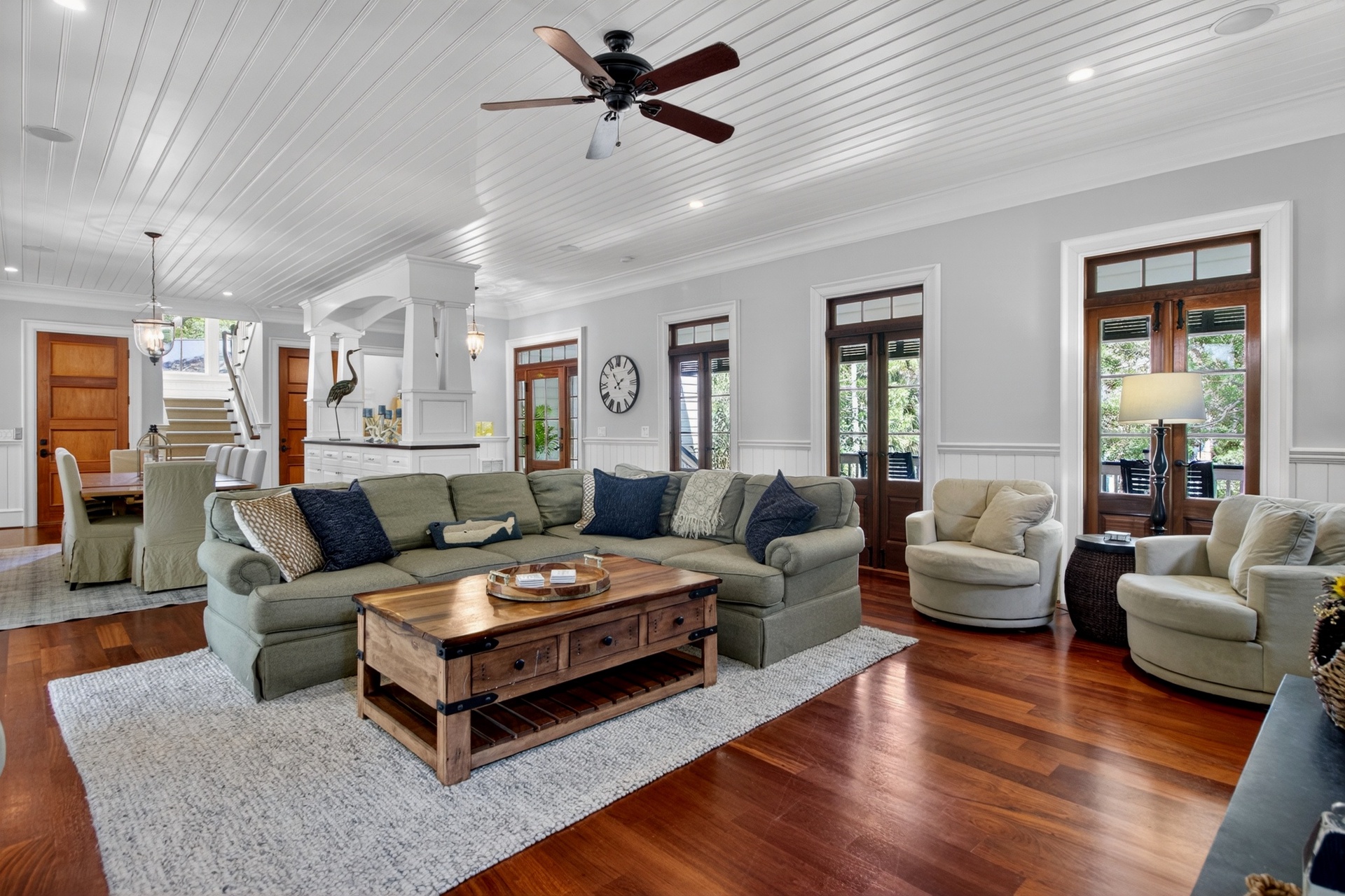 Sink into plush seating surrounded by gleaming hardwood floors and soaring ceilings, where natural light streams through elegant windows.