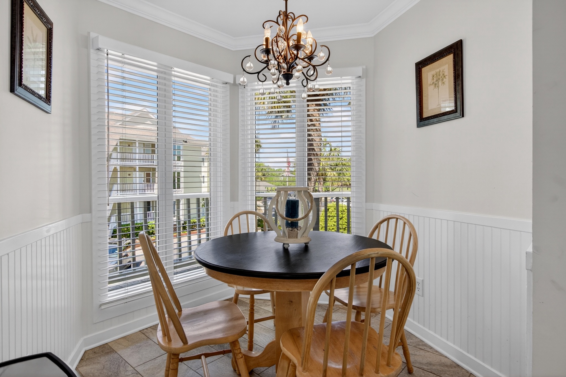 A sun-filled dining nook with charming neighborhood views and an elegant chandelier sets the scene for your morning coffee or intimate dinners during your stay.