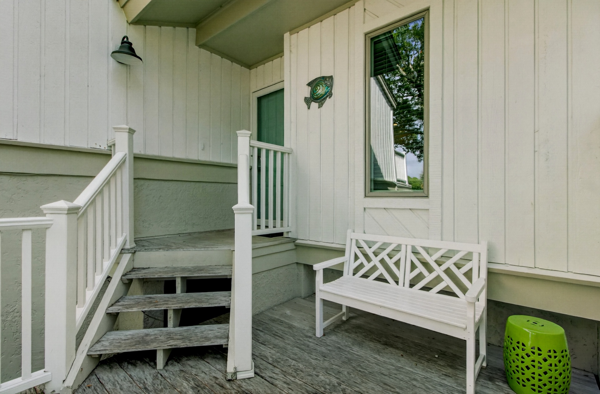 Step onto your welcoming covered porch, featuring a charming bench where you can sit and relax after your lakeside adventures.