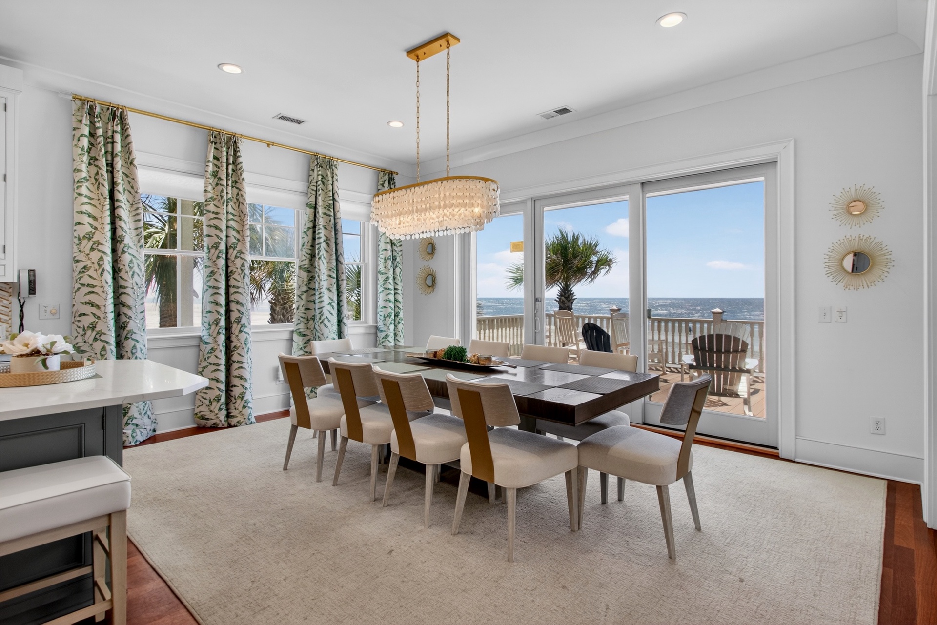 Your stunning dining room showcases ocean views through expansive windows, creating the perfect backdrop for memorable meals with family and friends.