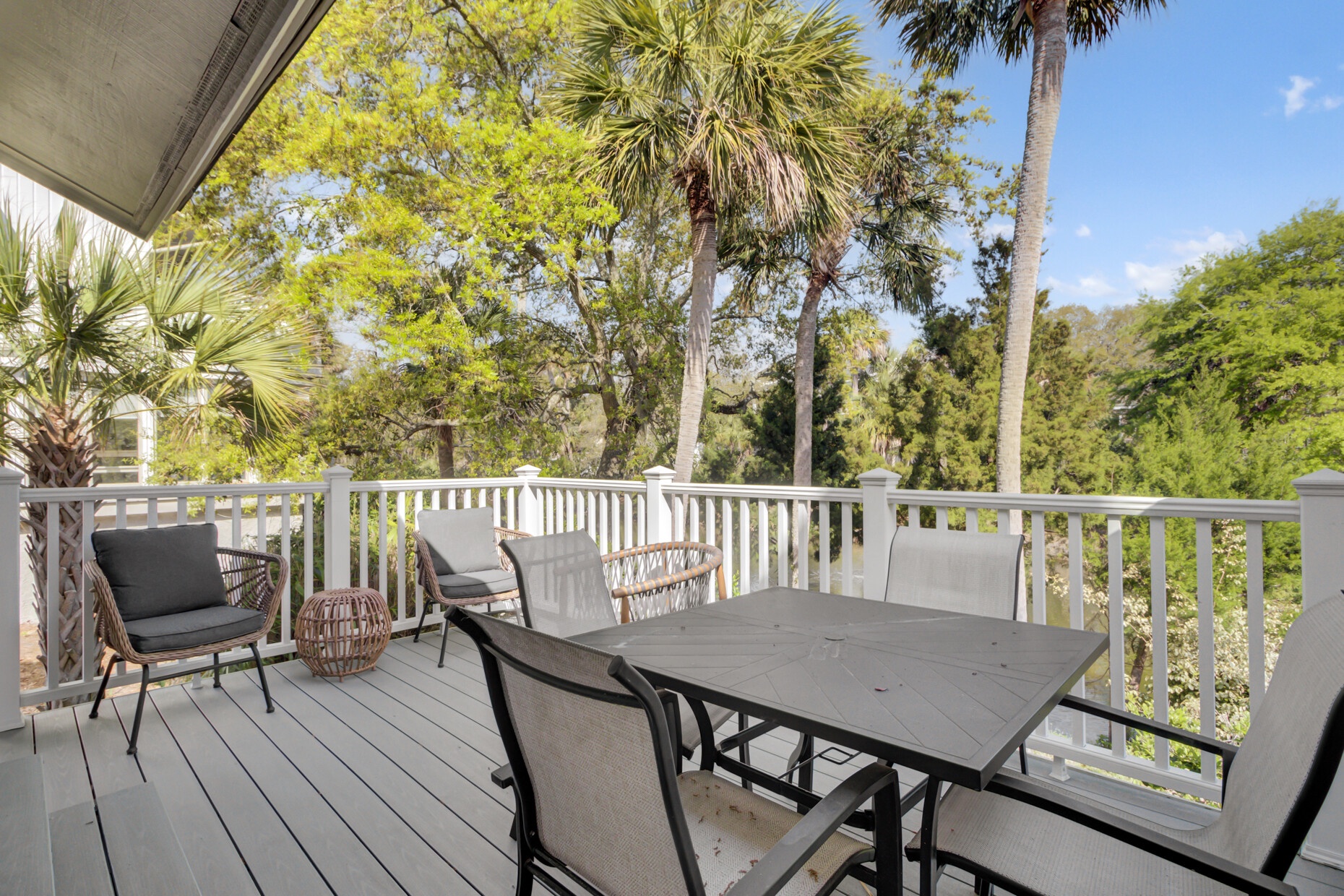 Step onto your private balcony and savor morning coffee while tropical palms sway in the breeze beyond the peaceful treetop canopy.