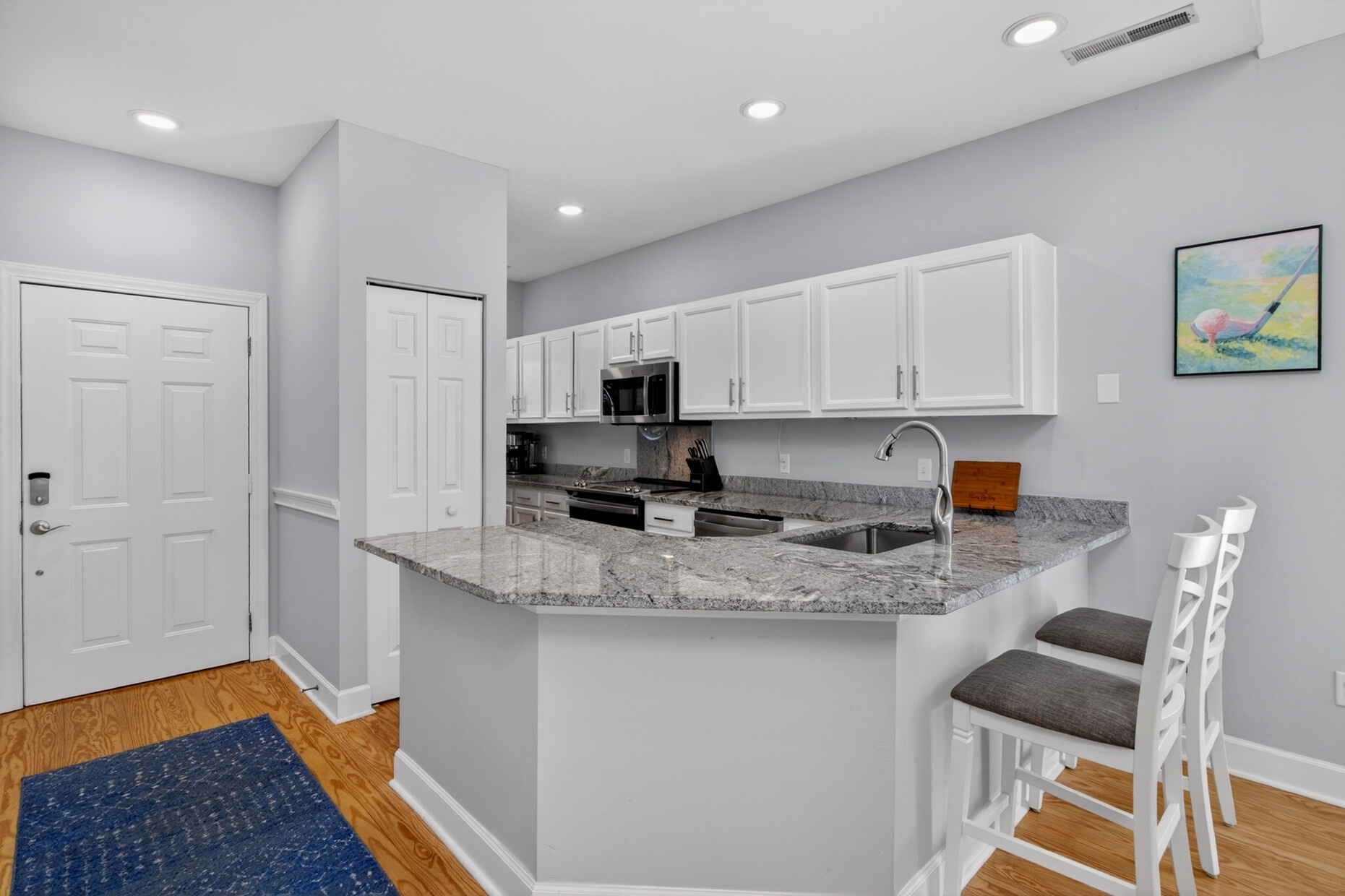 Your modern kitchen features granite countertops, stainless appliances, and a breakfast bar perfect for morning coffee or casual meals.