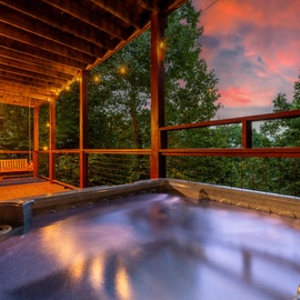 Sink into your private hot tub on the deck as the sky glows with sunset hues, surrounded by forest and mountain views—pure serenity awaits.