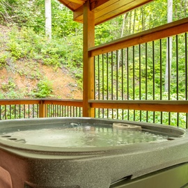 Your private hot tub awaits on this covered deck, where you can soak surrounded by lush forest and the peaceful sounds of nature. Let the warm water melt away your stress while birdsong and rustling leaves complete the scene.