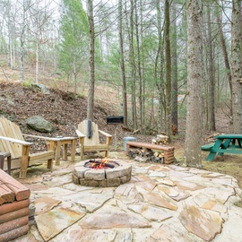 Gather around your private fire pit surrounded by Adirondack chairs and picnic tables, where crackling flames and forest tranquility create perfect evenings.