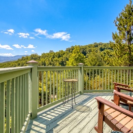 Settle into your private deck chairs and let your eyes wander across rolling forested hills and distant mountain ridges—your tranquil retreat where nature becomes part of the experience.
