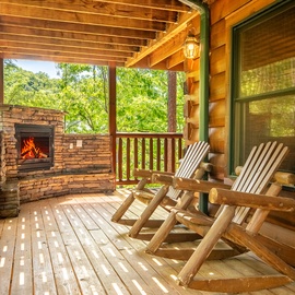 Picture yourself relaxing in one of these rustic rocking chairs on your private covered balcony, surrounded by lush forest views and warmed by your own outdoor fireplace.