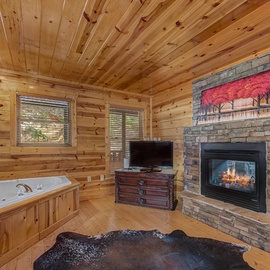 Unwind in your private retreat with a jetted tub and crackling fireplace, perfect for romantic evenings in this cozy cabin.