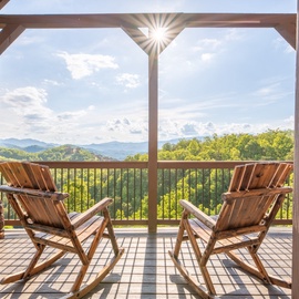 Step onto your private balcony and sink into a cozy chair—sweeping mountain views and rolling forest hills stretch endlessly before you, perfect for morning coffee or sunset relaxation.