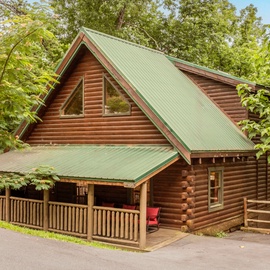 A welcoming log cabin retreat nestled among lush greenery, where rustic charm meets natural tranquility. Your secluded getaway features a covered front porch with forest views all around.