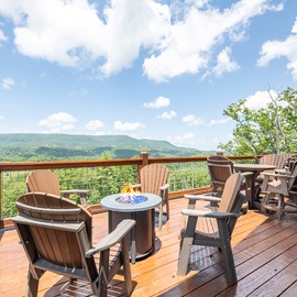 Expansive mountain views stretch across the horizon from your private deck, where Adirondack chairs and a fire table invite you to relax and soak in the fresh air.