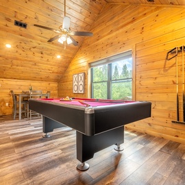 Challenge your friends to a game on your own full-size pool table surrounded by warm wood and natural light streaming through large windows.