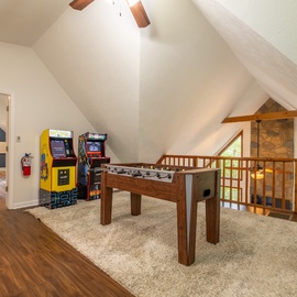 Step into your private game loft with classic arcade machines and foosball—where friendly competition and laughter fill vaulted ceilings bathed in natural light.