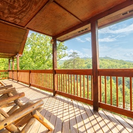 Relax in your private rocking chairs while taking in sweeping mountain views from this covered deck.