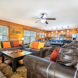 Gather your group in this spacious living room where plush leather seating and vibrant pillows create the perfect spot for relaxation and conversation.
