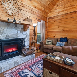 Sink into plush leather sofas in your cozy living room, where natural wood surrounds you and a glowing fireplace awaits those chilly evenings together.