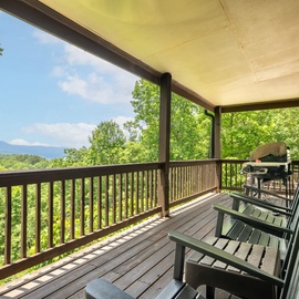 Sip your morning coffee and breathe in the fresh mountain air from your private covered deck, surrounded by lush forest canopy and distant peaks.