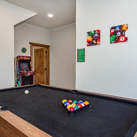 Challenge friends and family to pool and arcade games in your private game room, where fun and friendly competition await.