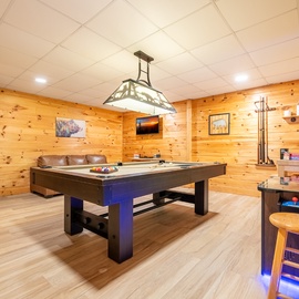 Challenge your travel companions to a friendly game in this inviting game room, complete with a full-size pool table and cozy seating perfect for unwinding after a day of adventure.
