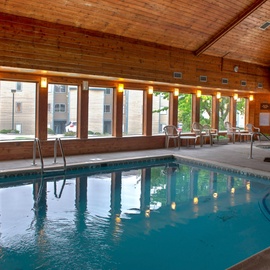 Take a refreshing dip in the community indoor pool, surrounded by warm wood tones and natural light streaming through picture windows. Relax poolside on comfortable seating after your swim.