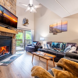 Cozy up in this inviting living room with a crackling stone fireplace and plush seating where your group can gather for memorable evenings together.