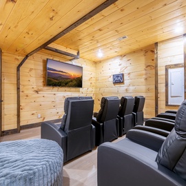 Sink into plush recliners in your private home theater, where movie nights become unforgettable experiences with cinematic comfort and stunning mountain views.