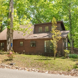 Charming woodland retreat nestled among towering trees offers peaceful seclusion with natural landscaping and rustic architecture perfect for forest getaways.