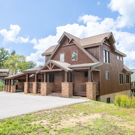 This impressive mountain retreat features spacious decks and stunning views of the surrounding forested peaks, perfect for enjoying the natural beauty of the area.