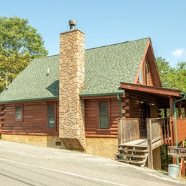 A charming log cabin nestled among mature trees—your mountain retreat awaits just off a quiet access road.