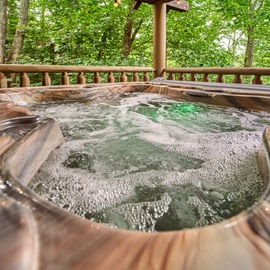 Soak your cares away in your private hot tub surrounded by lush forest—a peaceful outdoor retreat designed just for you.