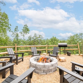 Gather around the firepit with mountain vistas stretching before you—perfect for sharing stories under the open sky while savoring meals from the outdoor grill.