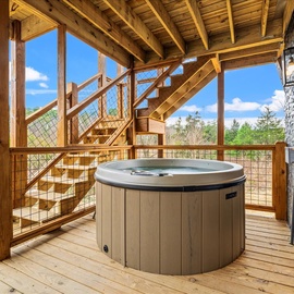 Soak away stress in your private hot tub on this stunning wooden deck, where mountain views and forest surroundings create perfect relaxation.