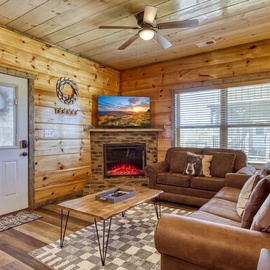Step into your cozy mountain retreat with warm wood tones throughout, plush leather seating, and a glowing fireplace that invites you to unwind after a day of adventure.