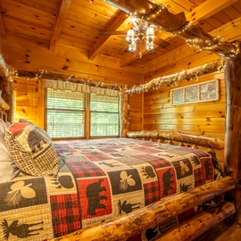 Sink into the cozy embrace of your rustic log bed, adorned with warm cabin quilts and twinkling fairy lights overhead.