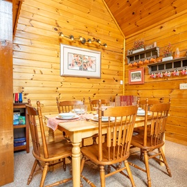 Gather around this warm wooden dining table for memorable meals together. The cozy cabin charm and thoughtful touches make every dinner feel like home.