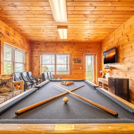 Challenge your friends to a game in your private game and theater room, where warm wood paneling and mountain décor create the perfect setting for relaxed competition and laughter.