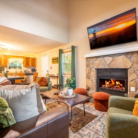 Gather around the stone fireplace in this welcoming living space, where plush seating set the scene for your cozy retreat moments together.