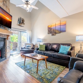 Unwind in your spacious living room where vaulted ceilings and a crackling stone fireplace create the perfect mountain retreat.