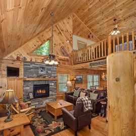 Sink into plush leather seating beside your crackling stone fireplace in this warm log cabin retreat.