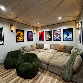 Settle into your private movie theater with plush seating and movie posters creating the perfect entertainment escape.