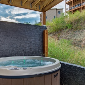 Soak away your cares in your own hot tub, tucked beneath a covered patio with hillside views and total relaxation just steps from your door.