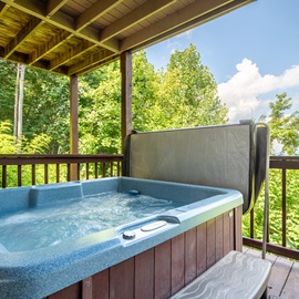 Soak in your private hot tub on a covered deck surrounded by lush forest views—your perfect retreat after a day exploring the area.