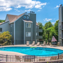 The resort features a welcoming heated seasonal outdoor pool area with lounge chairs, perfect for a sunny getaway.