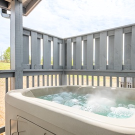 Soak away your stress in your private hot tub on the deck, with countryside views stretching beyond.
